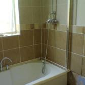 The shower and fittings go on