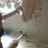 The old, broken tiles come off